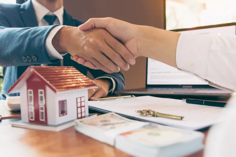 a realtor shaking hands with their client